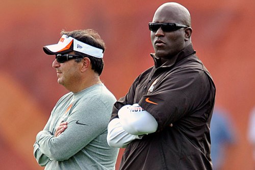 Mike Lombardi (former GM) and Ray Farmer (current GM) watch a Browns practice in 2013. (Photo via SI)